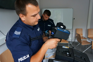 Policjanci z wydziału ruchu drogowego oglądają nowe laserowe mierniki prędkości